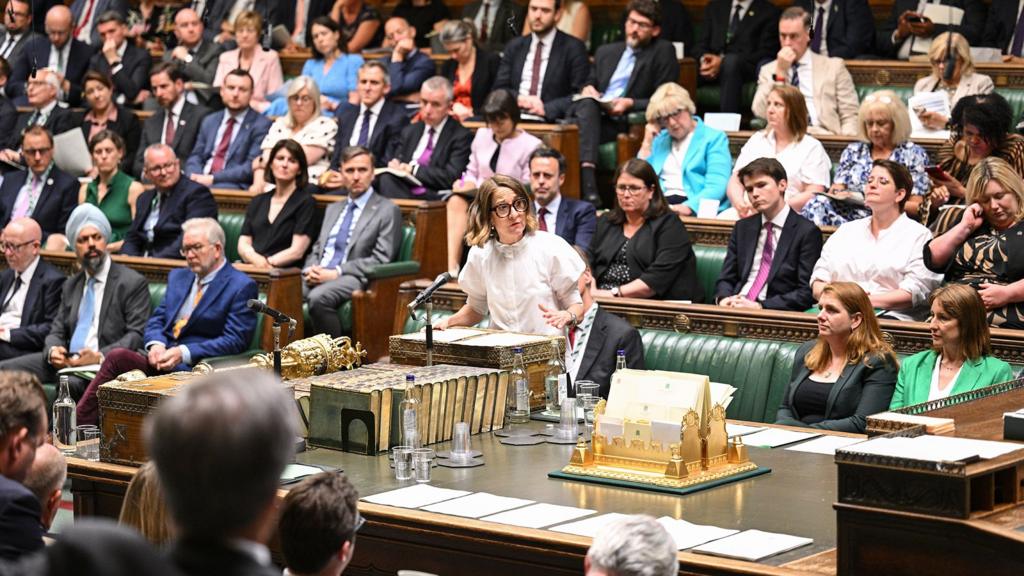 Wide shot of Liz Kendall gesturing as she speaks into a microphone in the Commons on Monday
