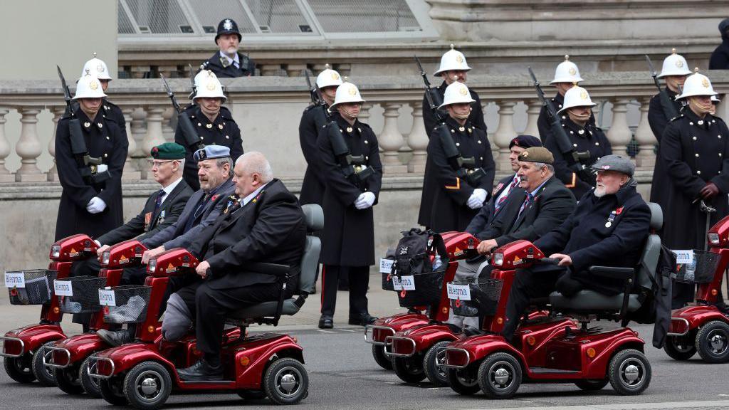 Veterans ride on scooters in Whitehall