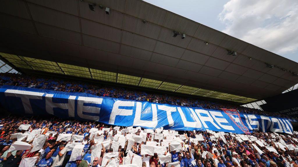 Ipswich fans hold up 'The Future is Now' flag