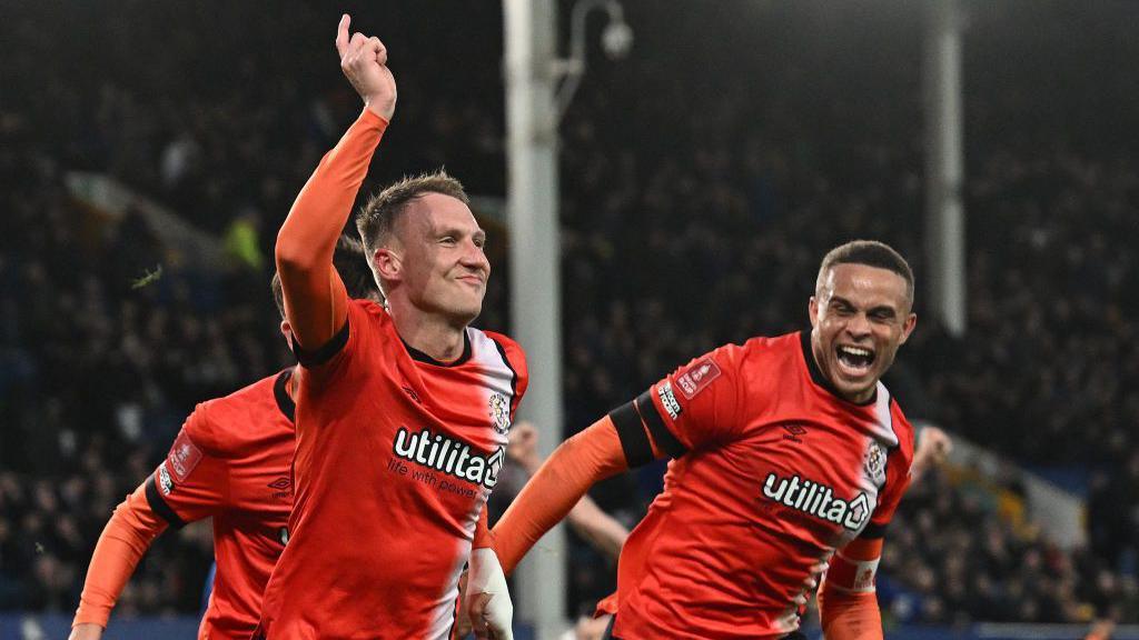 Luton Town's English striker #10 Cauley Woodrow celebrates scoring the team's second goal during the English FA Cup fourth round football match between Everton and Luton Town at Goodison Park