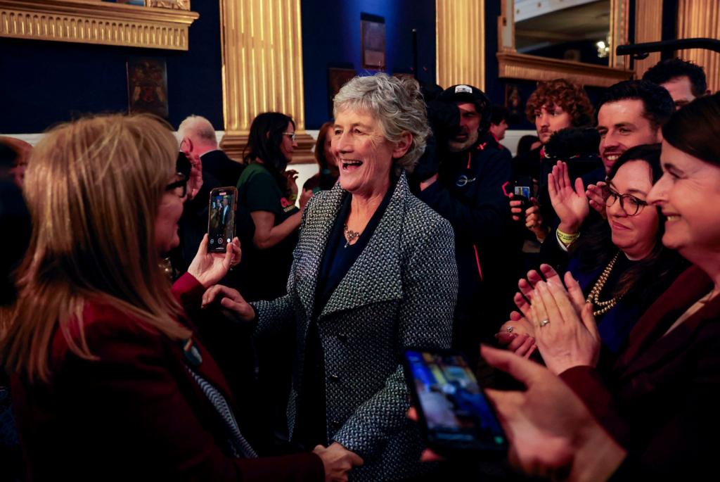 Catherine Connolly has grey hair and is smiling in a group of people
