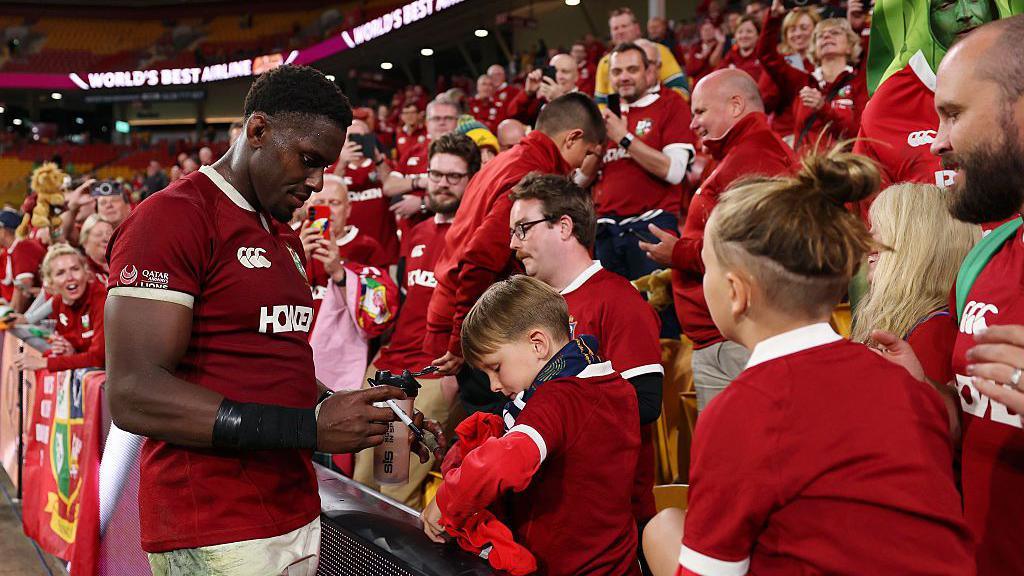 Maro Itoje signing autographs