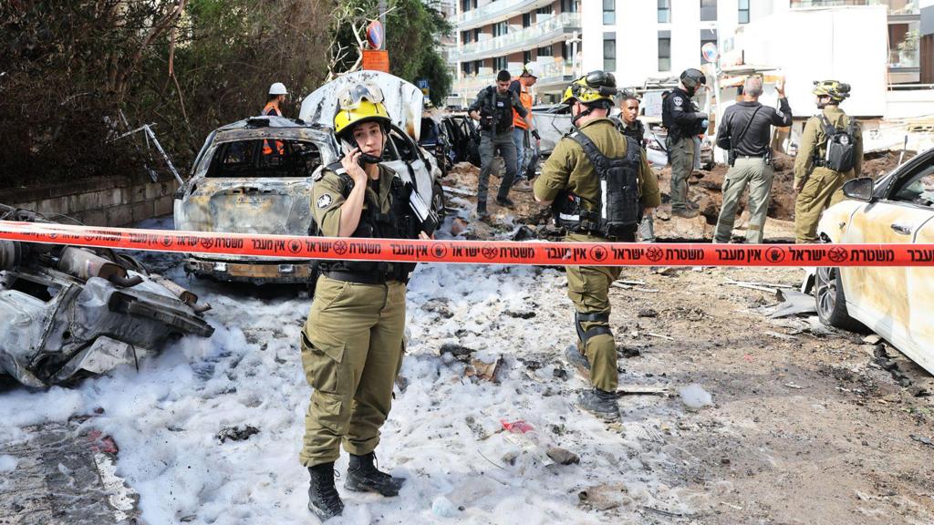 Israeli emergency teams work at the site of an Iranian missile strike in Tel Aviv