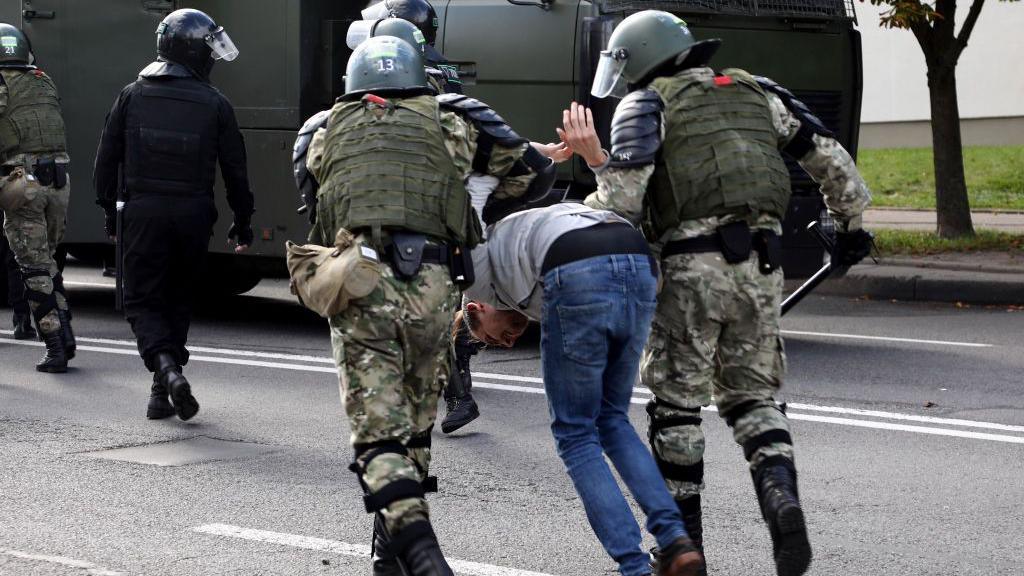 Law enforcement officers detain a man during a rally to protest against the presidential election results in Minsk on September 13, 2020