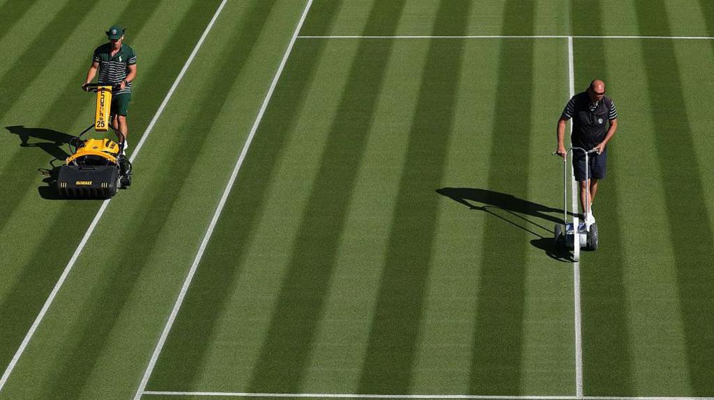 The grass being cut and lines repainted on the Wimbledon tennis court