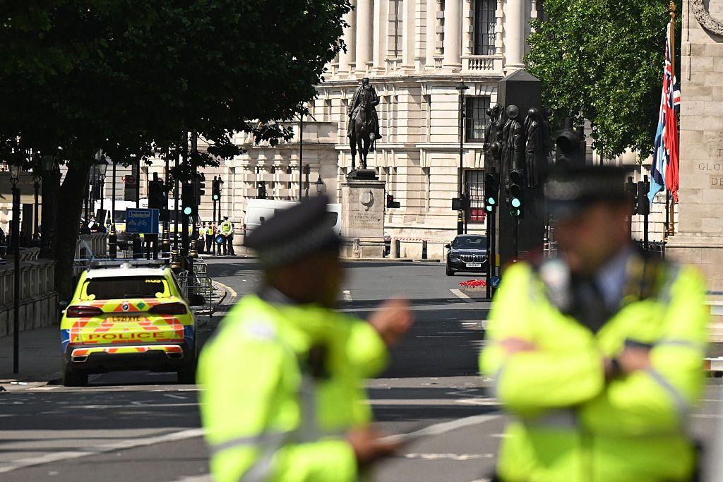 Met Police at Whitehall. The buildings are in focus and the police are in the foreground, blurred.