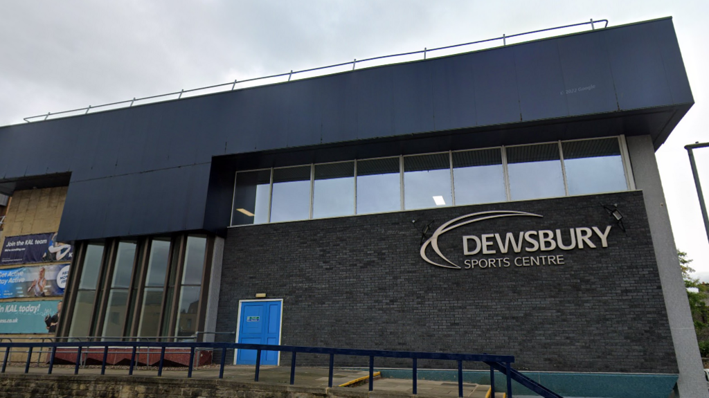 An external view of Dewsbury Sports Centre, with its name in large letters on the side of the building