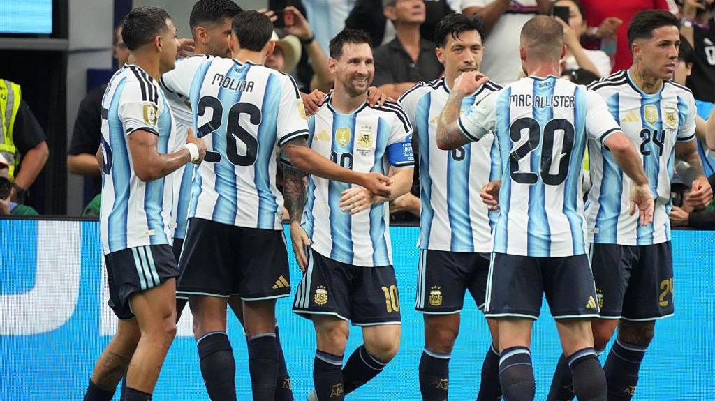 Messi celebrating with teammates after scoring against Austria.