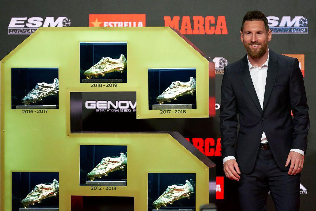 Lionel Messi poses alongside his six European Golden Shoe trophies in 2019