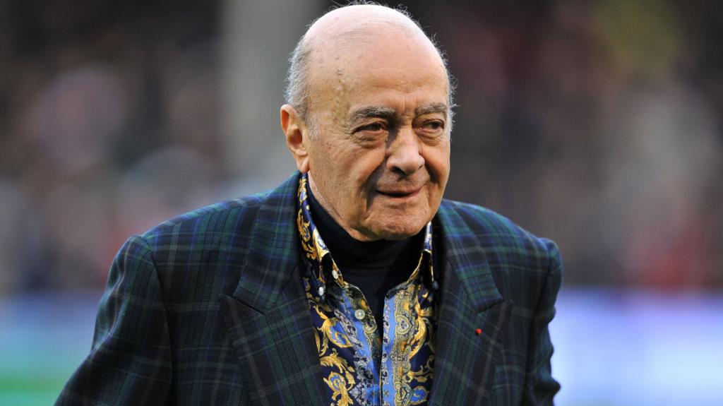 Mohamed Al Fayed, wearing a tartan-style jacket, smile and looks off to the right (file photo from 2013)