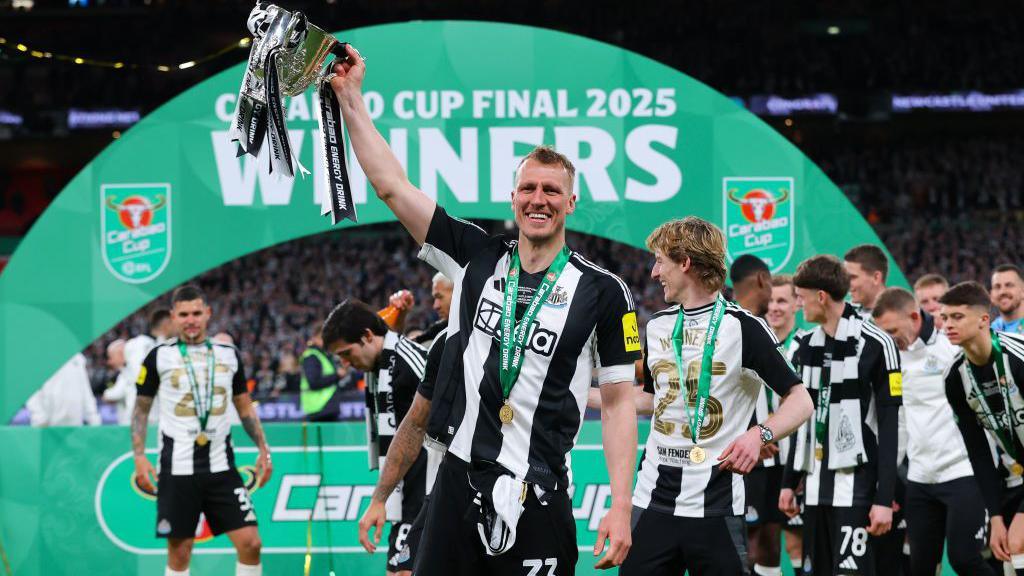 Dan Burn celebrates with the Carabao Cup trophy