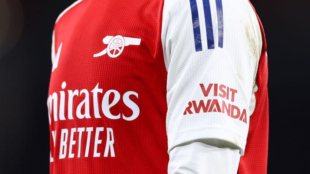 An image of an Arsenal shirt with the 'Visit Rwanda' logo on the sleeve