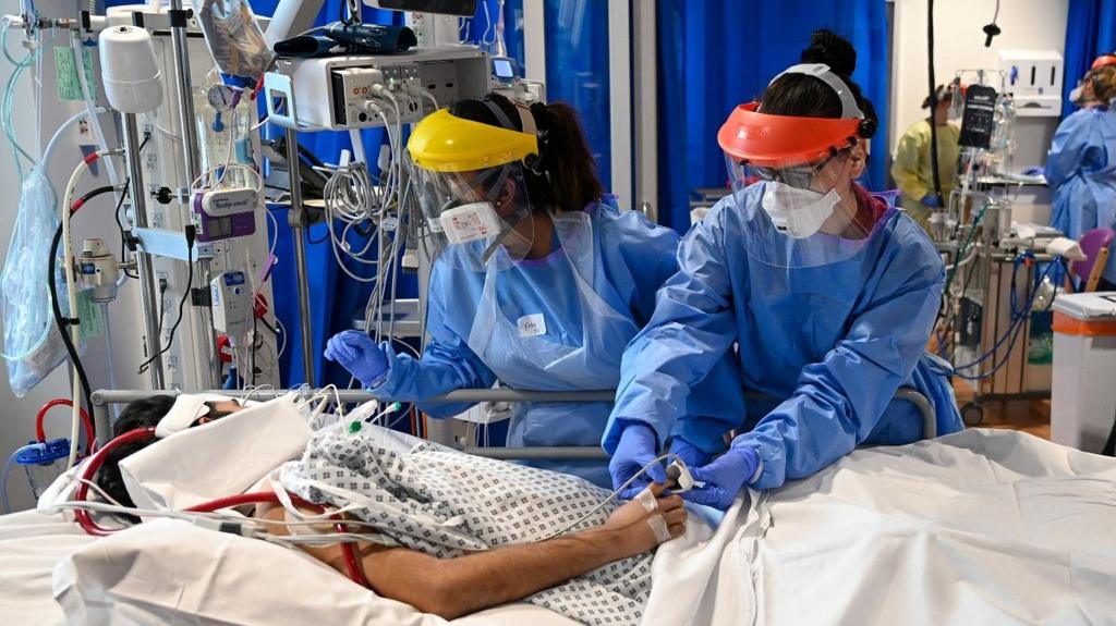 Clinical staff in PPE tend to a patient in Royal Papworth Hospital in May 2020