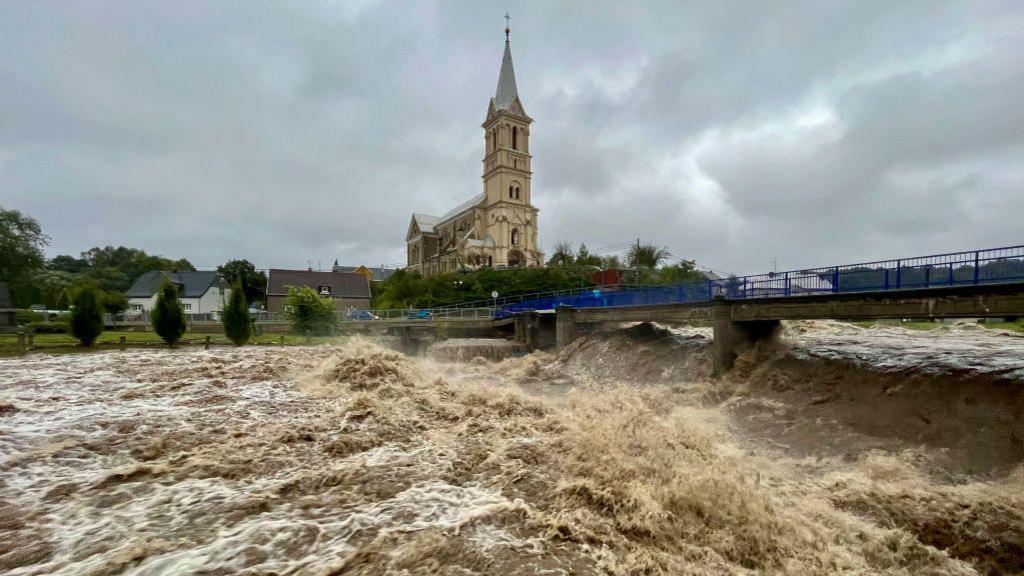 A torrent of water flows along the river Bela during heavy rain in Mikulovice, Czech Republic.