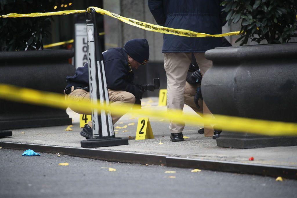 Police place bullet casing markers outside of a Hilton Hotel in Midtown Manhattan on 4 December 2024 