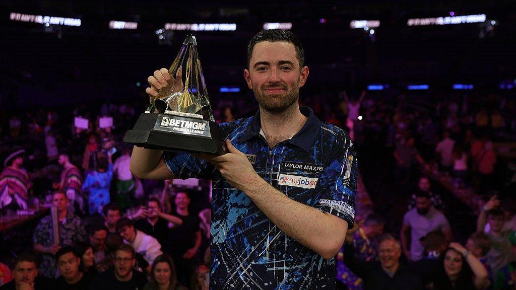 Luke Humphries with the Premier League darts trophy after winning in 2025
