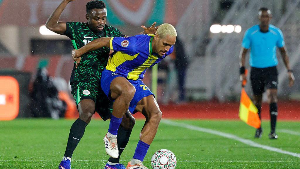 Footballer Haji Mnoga protects a ball on a pitch while playing for the Tanzania national football team at the Afcon 2025.