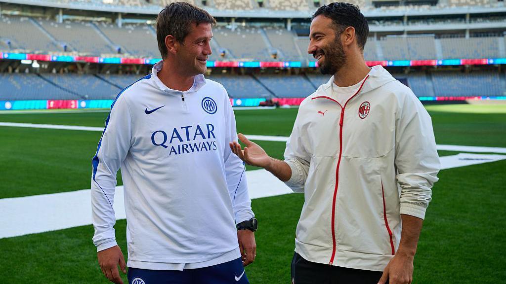 New AC Milan manager Ruben Amorim speaks with Inter's Christian Chivu during the teams' pre-season tour in Australia