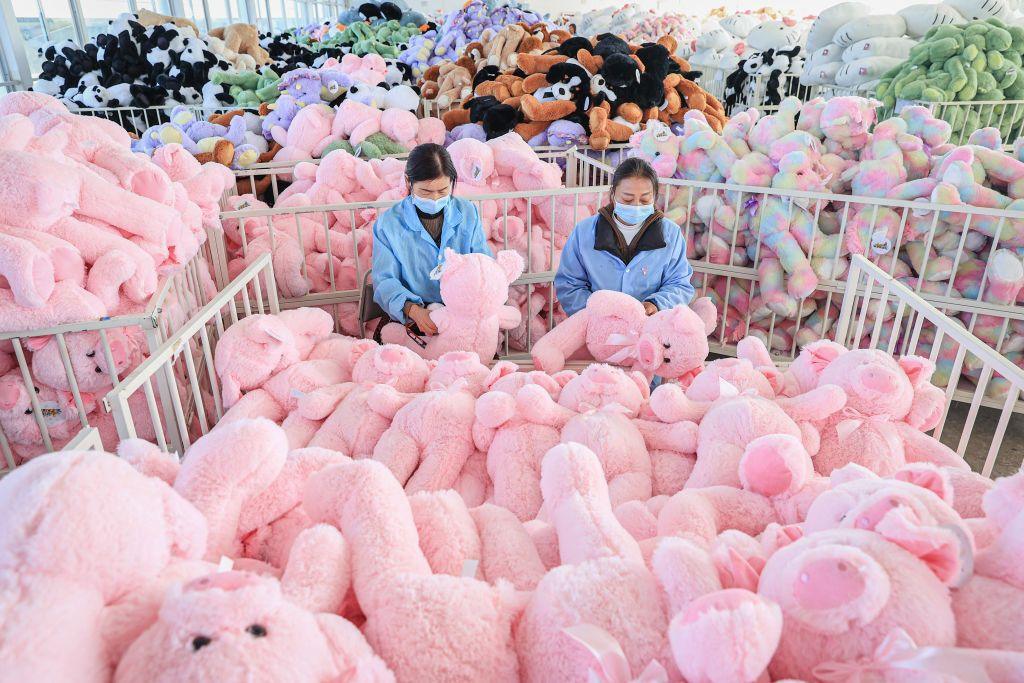 Employees work on a production line of stuffed teddy bears 