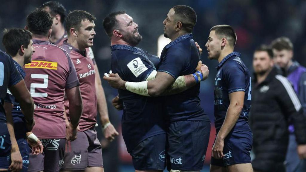 Castres' English prop Will Collier (centre-left) and French flanker Mathieu Babillot (centre-right) celebrate after winning the European Rugby Champions Cup pool 3 match against Munster 