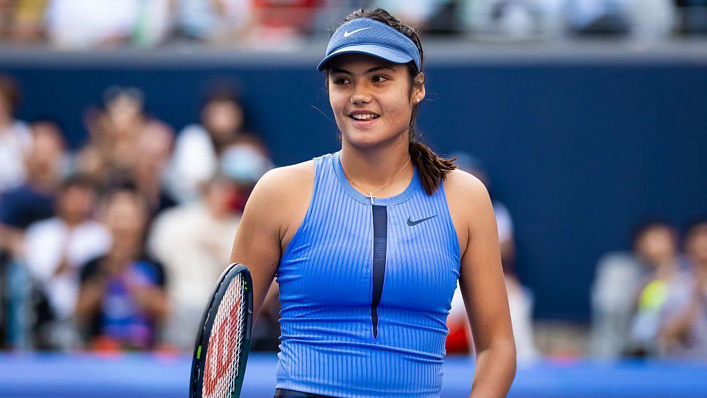 Emma Raducanu holding a racquet