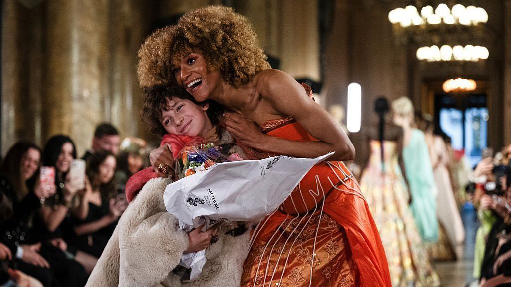 Max getting a cuddle from one of the models