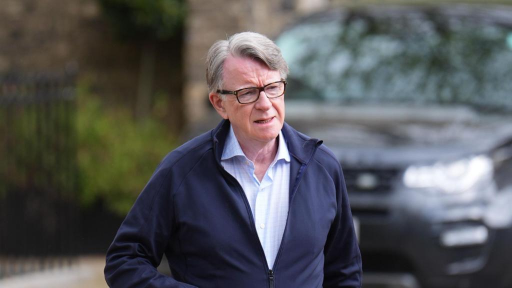 Peter Mandelson pictured as he walks outside his home