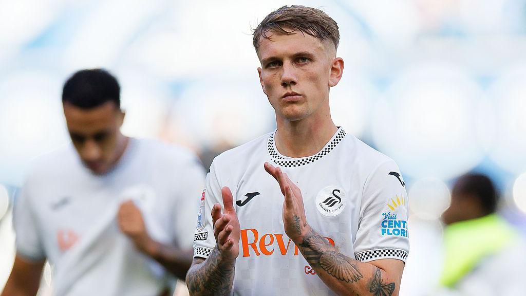 Ethan Galbraith applauds after a Swansea game