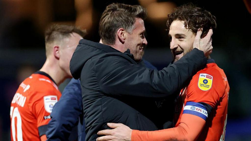 Rob Edwards, manager of Luton Town celebrates with Tom Lockyer