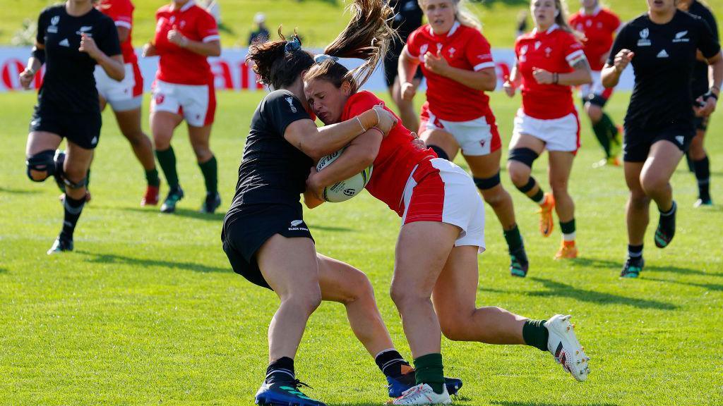 Kayleigh Powell of Wales is tackled by Portia Woodman of New Zealand