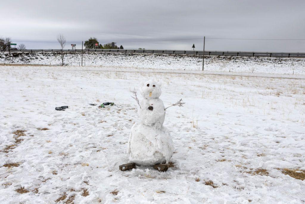 A photo shows a snowman on a snow covered sports field in Warden, Free State province, South Africa, on September 21, 2024.