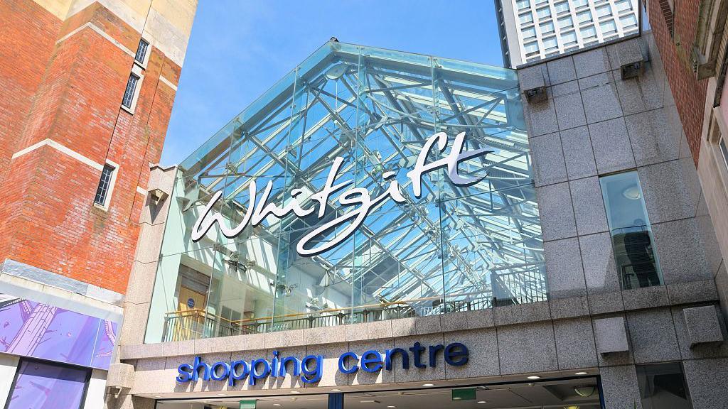 A glass exterior for the Whitgift Shopping Centre, with signs above the entrance
