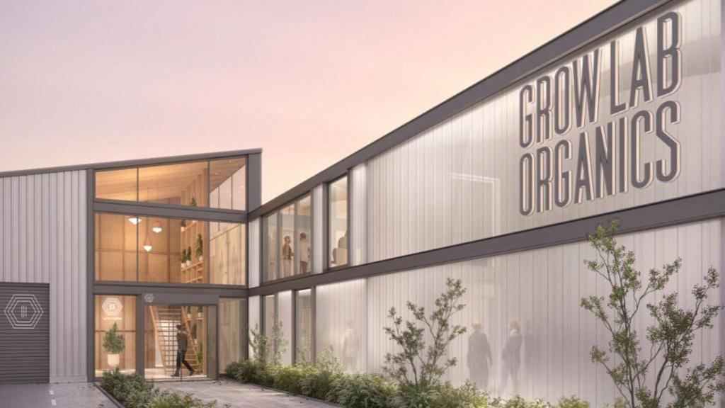 An artist's impression of the exterior of the facility, it shows a two-storey grey building with a sign that read Grow Lab Organics. It has an entrance that is double door made of glass.