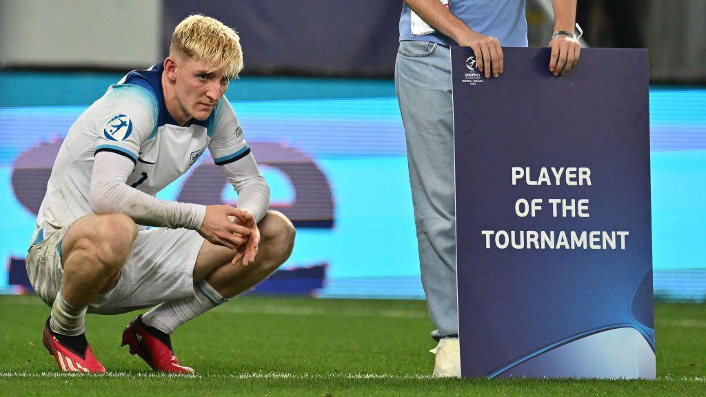 Anthony Gordon of England with a banner which reads 'player of the tournament' at the European Under-21 Championship in 2023.