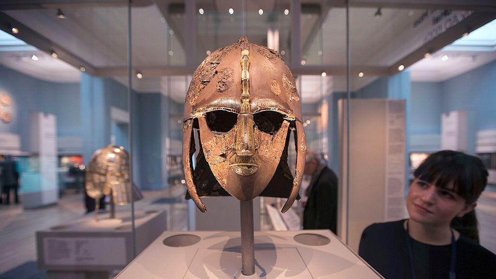 A woman looking at the Sutton Hoo Helmet in the British Museum.