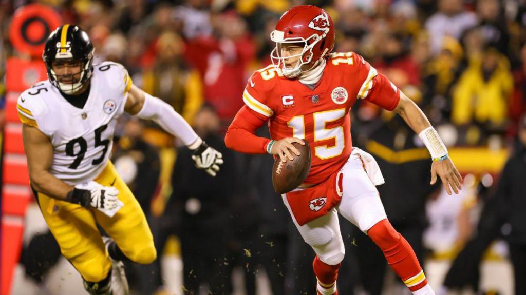 Patrick Mahomes running away from a Pittsburgh Steelers player