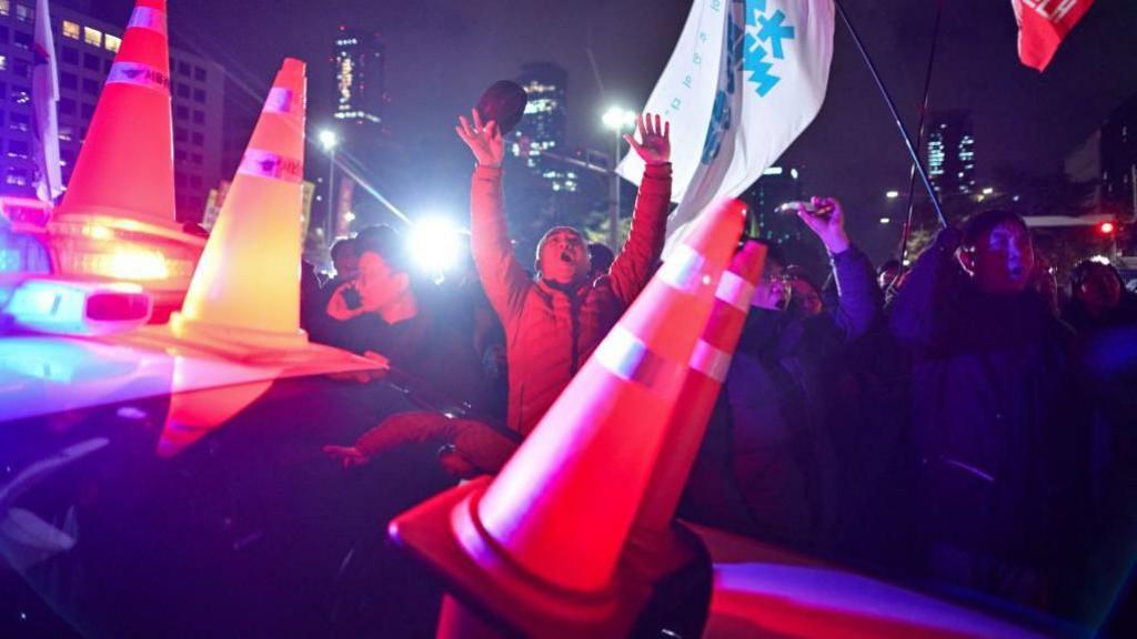 Protesters outside the National Assembly building