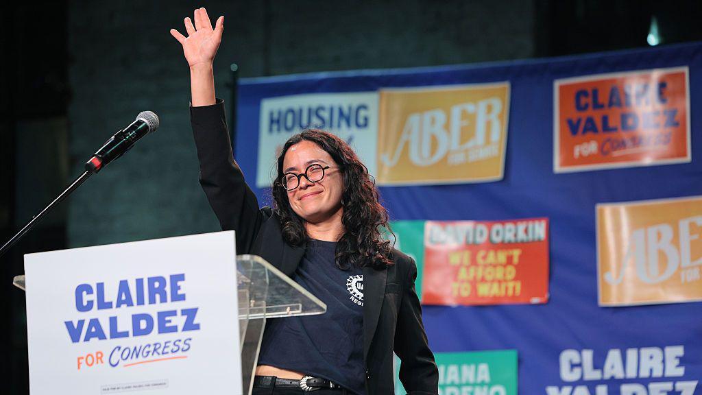 Claire Valdez holds her arm up. 