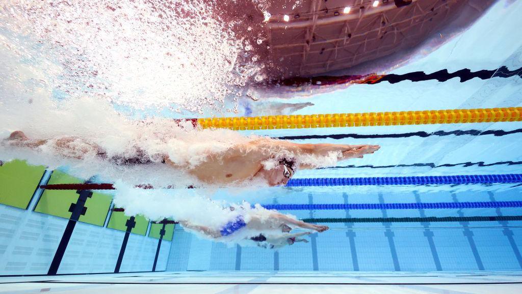 Athletes diving into the water at the 2022 Commonwealth Games in Birmingham.