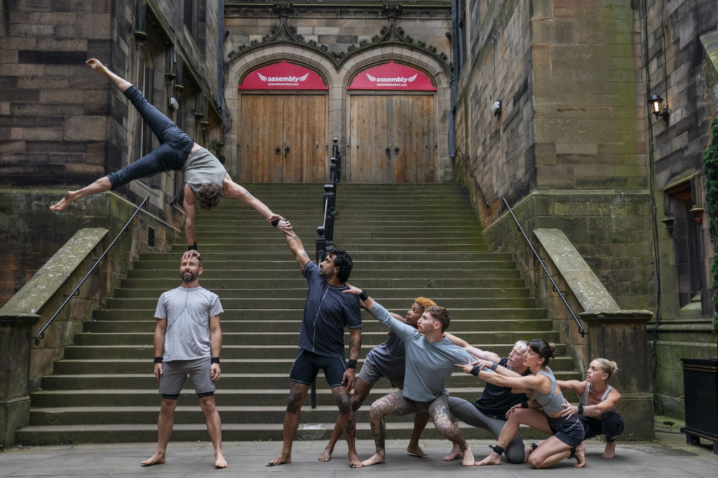 Acrobats do balancing act in front of some stone steps