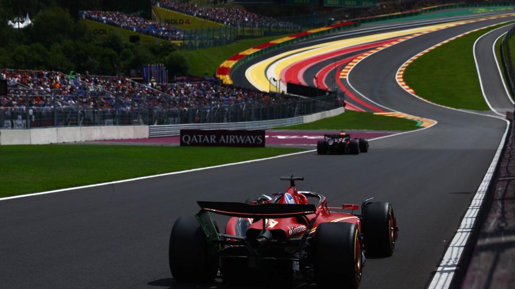 A rear position of Charles Leclerc's Ferrari heading towards Eau Rouge during nan 2024 Belgian Grand Prix