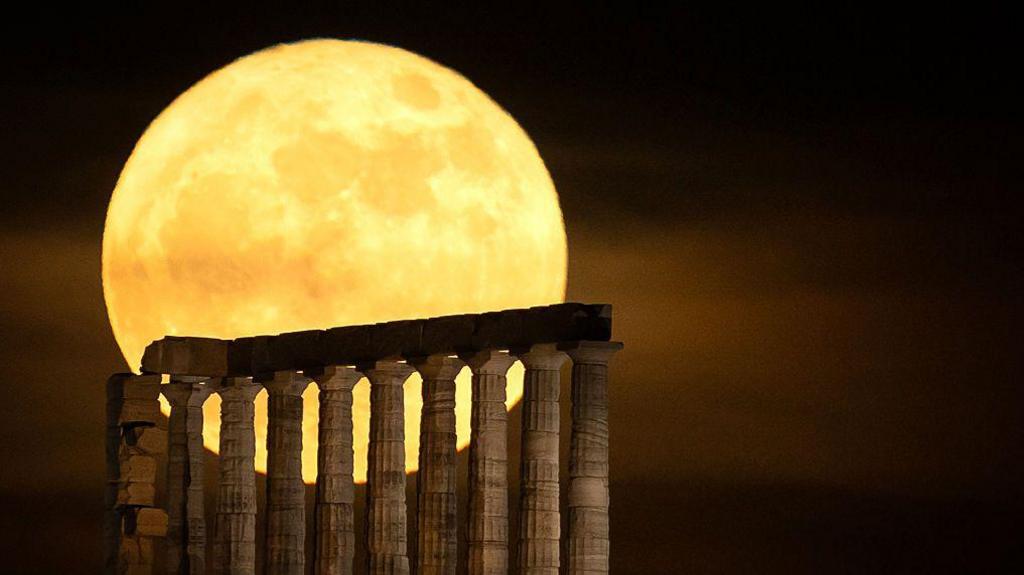 The full moon, known as the Blue Moon, rises over the Temple of Poseidon on Cape Sounion near Athens, Greece, on May 31, 2026. 