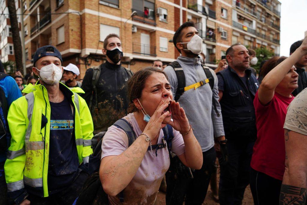 A woman shouts in the crowd