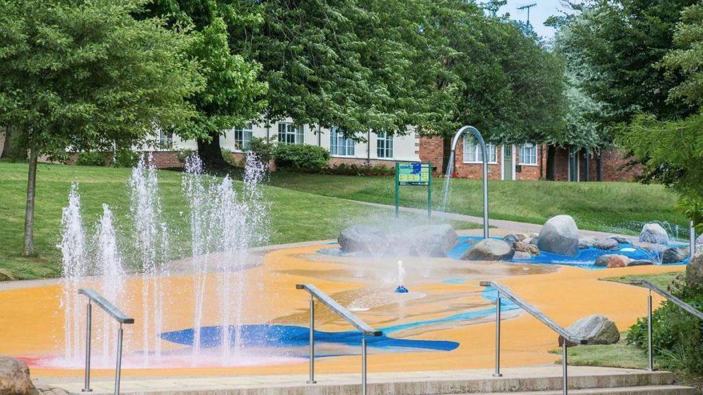 Yellow and blue splashpad with water fountains