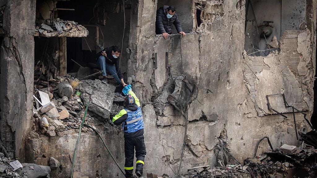 People collect belongings from a destroyed building as cleanup efforts continue after yesterday's Israeli airstrikes on April 09, 2026 in Beirut, Lebanon