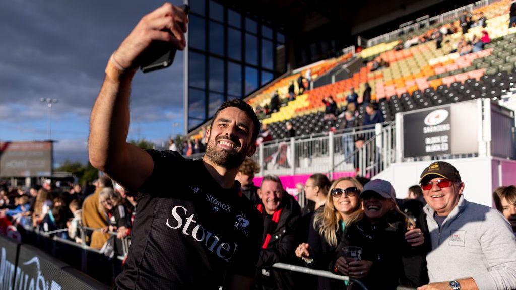 Alex Lozowski takes a selfie with fans