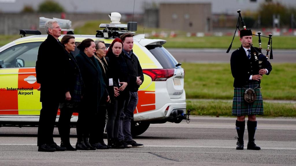 Family and frinds stand guard at Aberdeen Airport