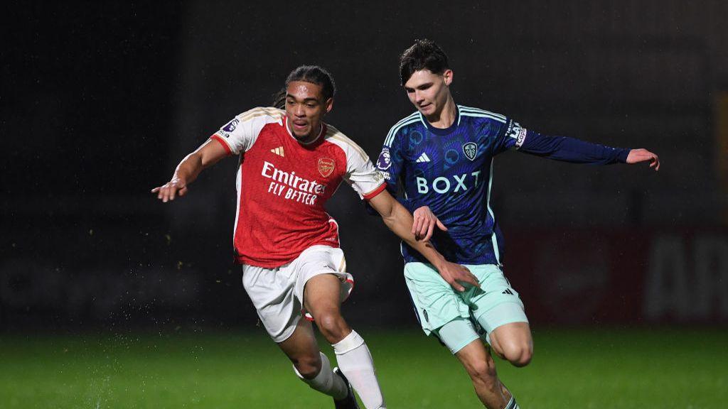 Arsenal youngster Josh Robinson battles it out with Leeds United's Charlie Crew