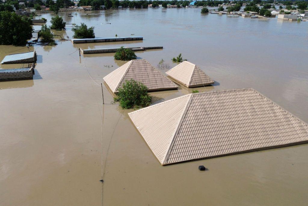 Roofs appear to float on water after devaastating floods.