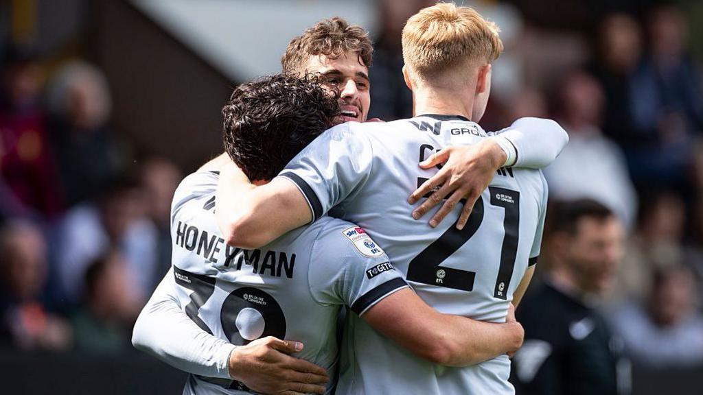 George Honeyman [left], Mihailo Ivanovic [centre] and Josh Coburn [right] celebrate after Ivanovic scores for Millwall against Burnley